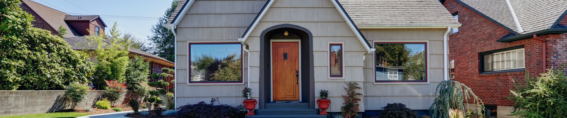 A beige home with a wooden door